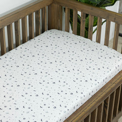 Dreamology Planets crib sheets used on toddler bed illustrating wrinkle-free bedding transition.
