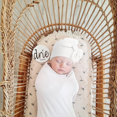 DRESHOW BQUBO bow hat on baby highlights stretchy fit for growing heads.