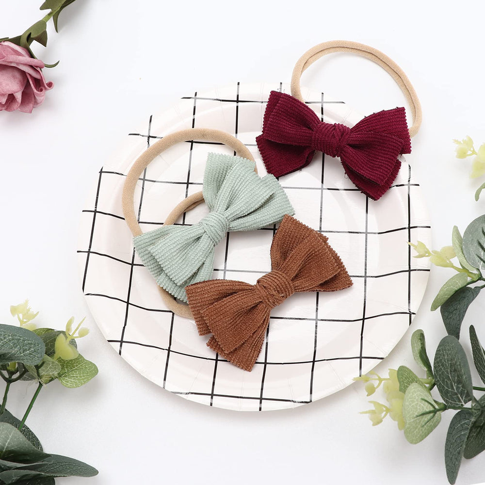 DRESHOW BQUBO infant headbands on baby demonstrating secure fit and stretch.