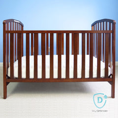 Dry Defender crib pad side view highlights four-layer protection and leak resistance