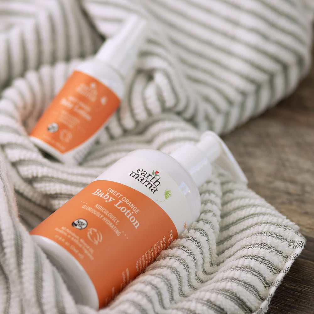 Earth Mama Sweet Orange Baby Lotion eco friendly packaging shown.
