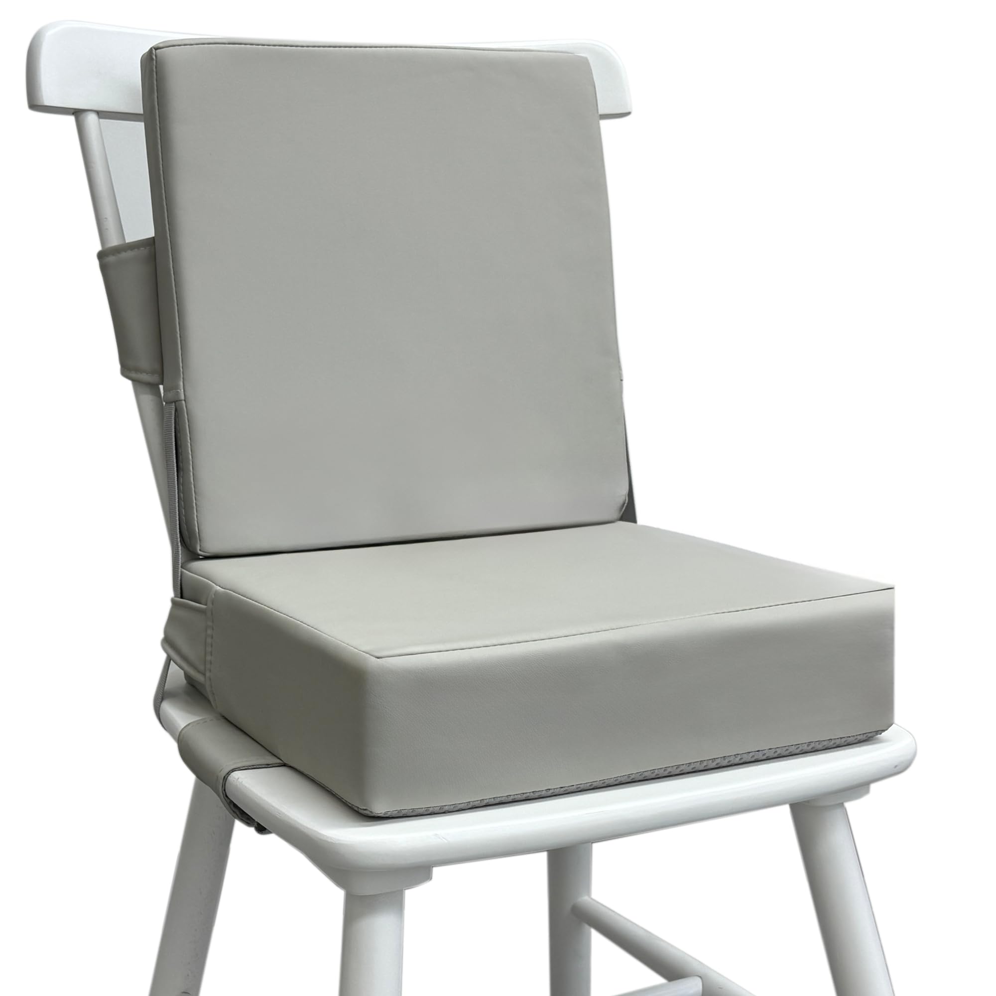 Eiury booster seat on a dining table in light grey, showing sturdy seating at mealtime