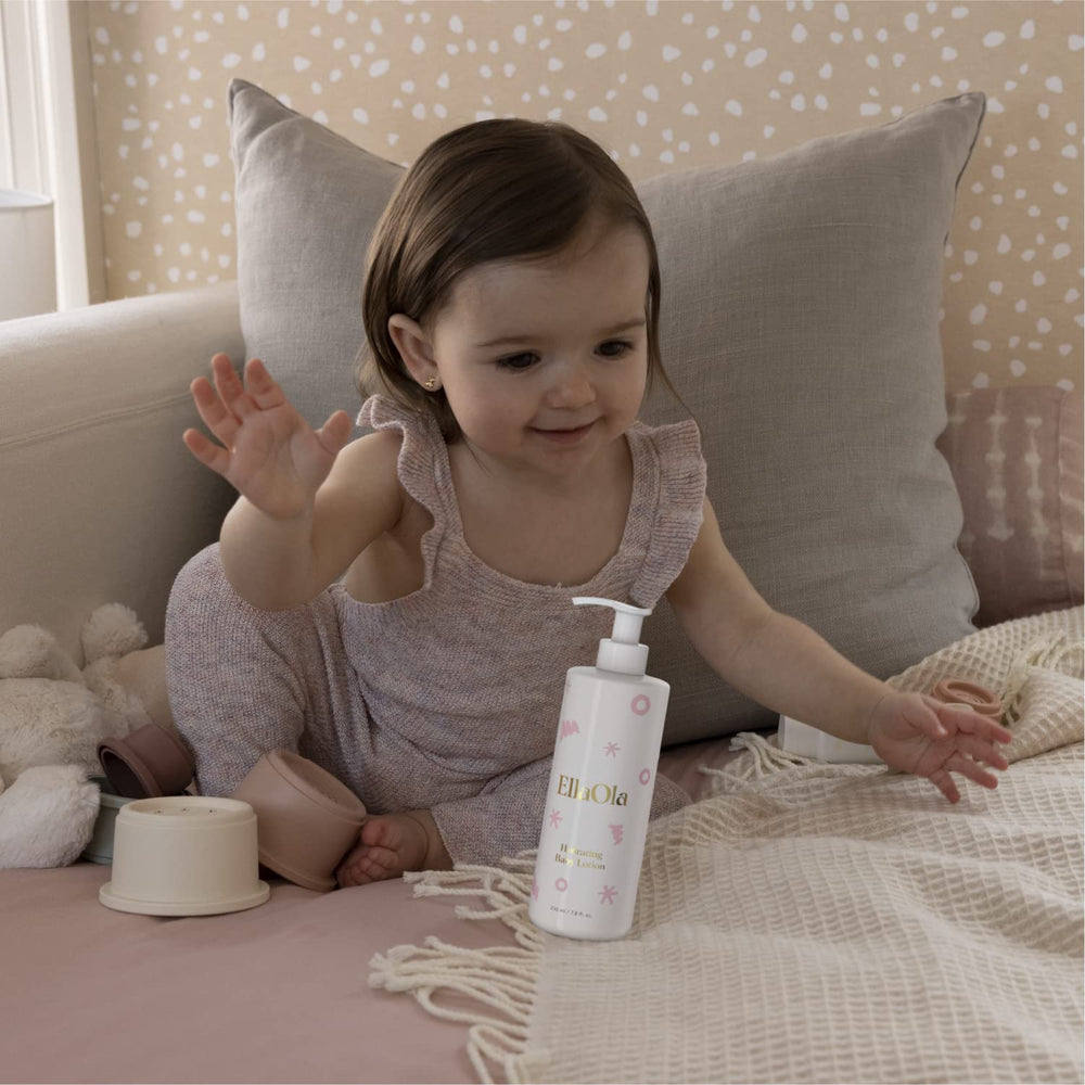 ELLAOLA newborn-care scene highlights daily moisturizing routine.