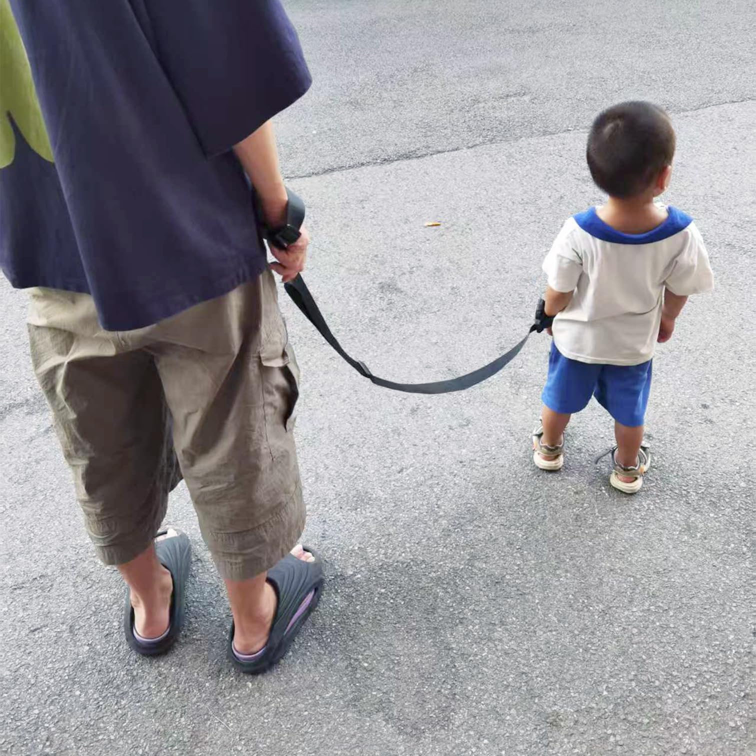 ELLENTAE escape-proof leash on child harness in crowded park settings.