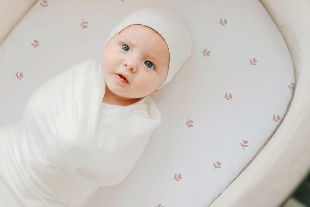 Universal-fit 32x16x3 bassinet sheet shown for snug coverage.