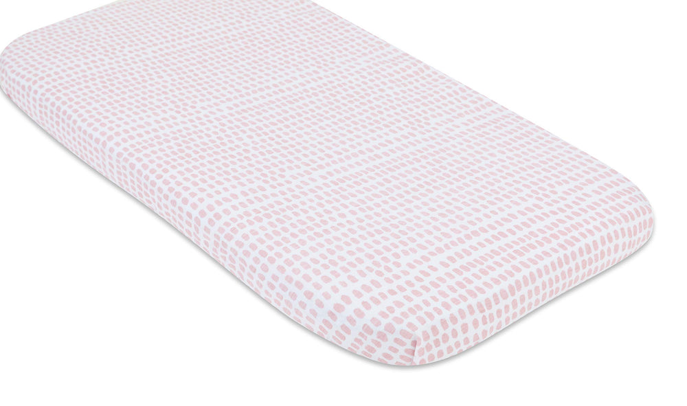 Machine-washable bassinet sheet image communicates easy cleanup after spills