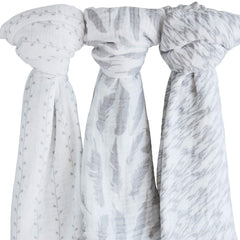 Ely's & Co muslin swaddle demonstrates newborn swaddling in a cozy nursery.