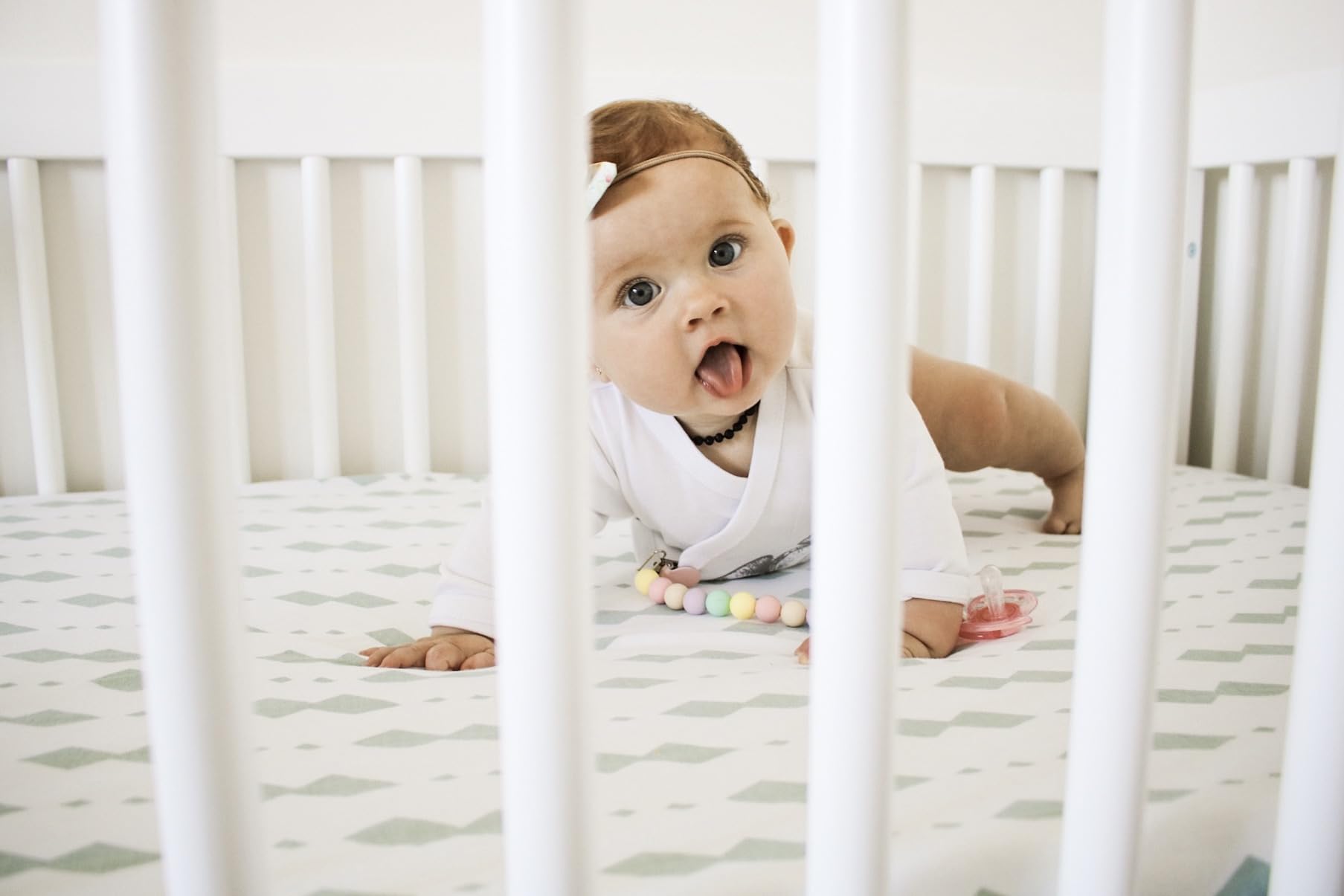 Ely's & Co. sheet in unisex grey-sage complements any nursery decor