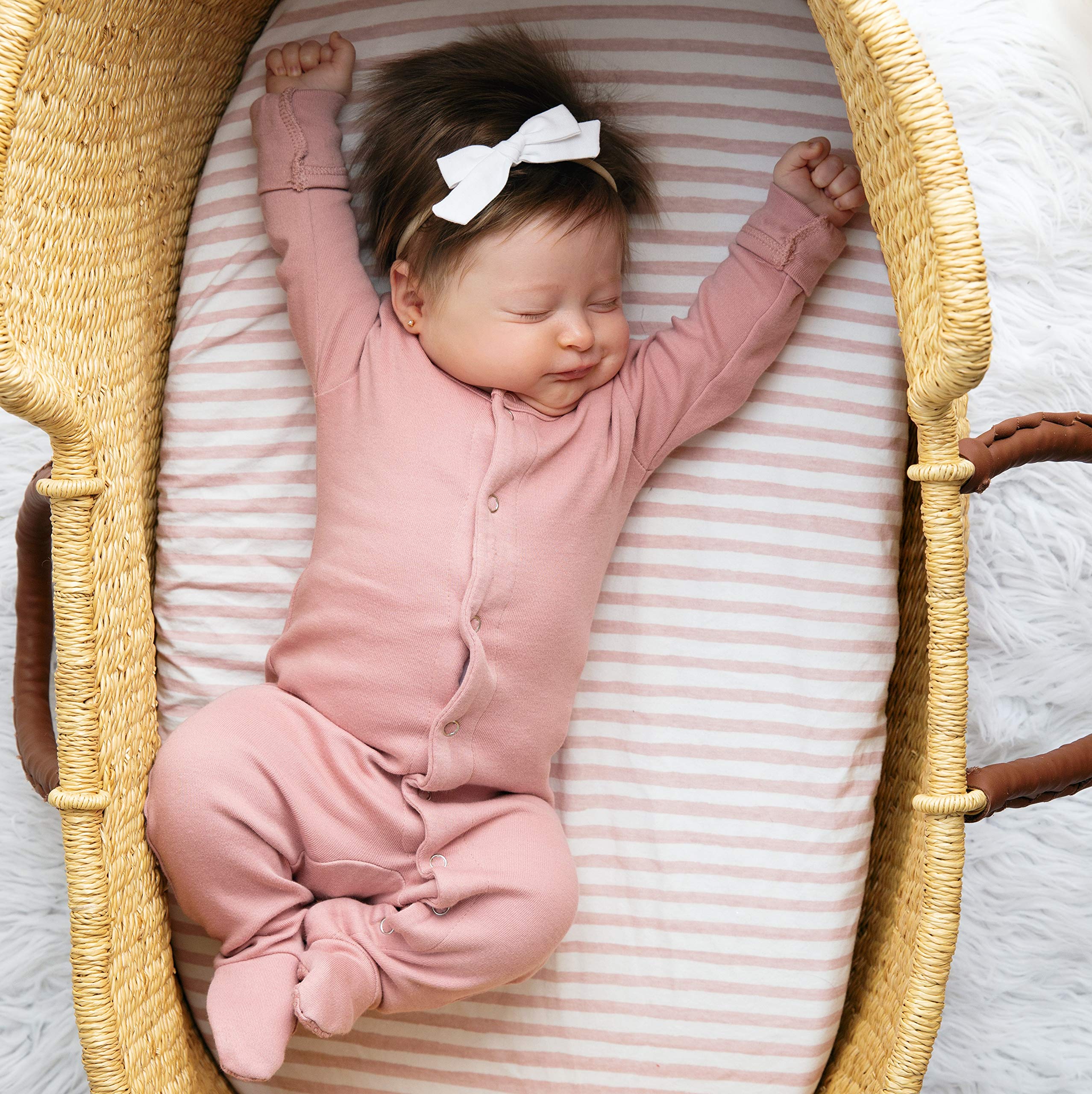 Pattern close-up shows mauve stripes and splash designs for nursery styling