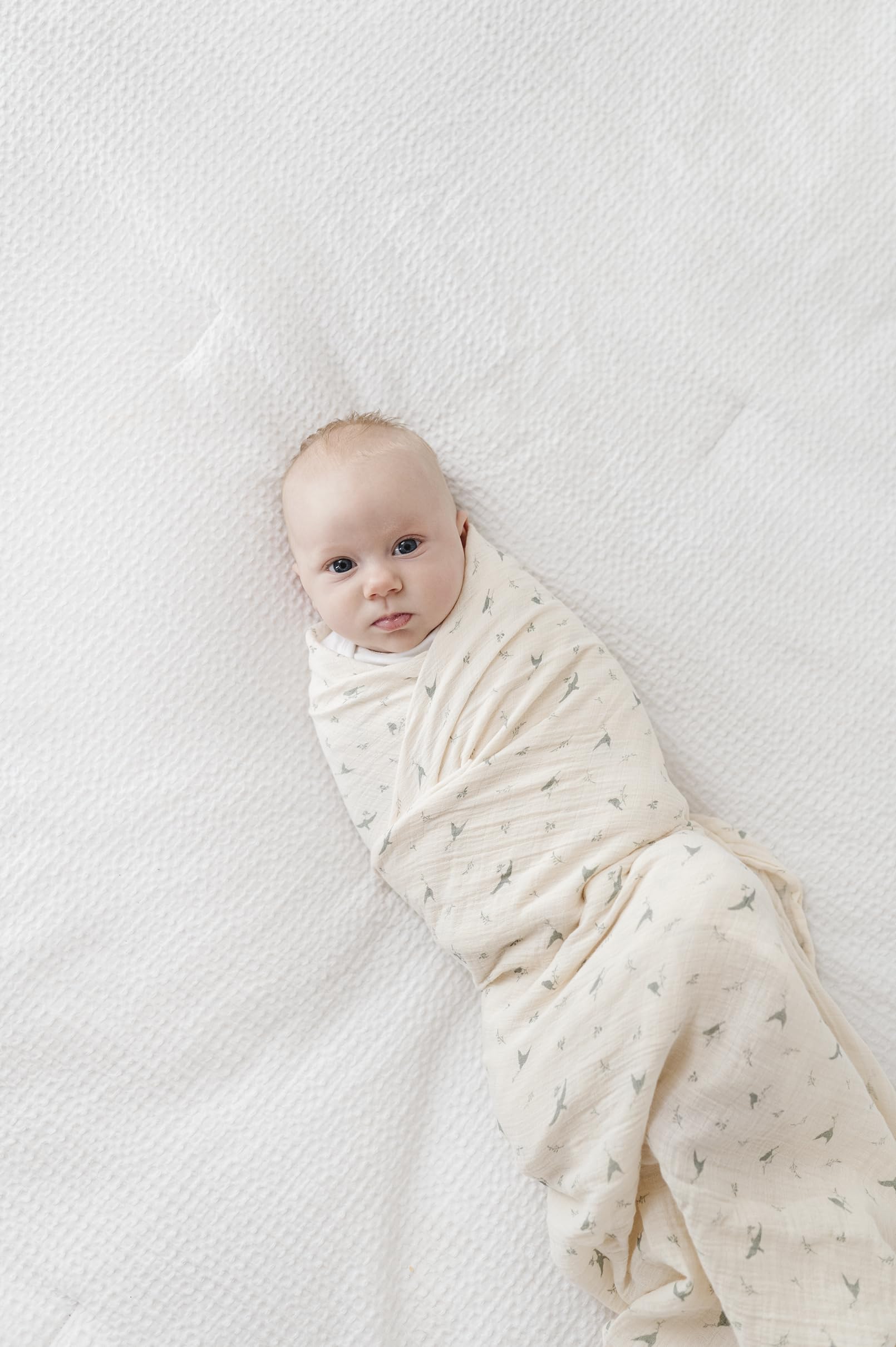 Ely's & Co sage bird swaddle gift-packaging signals ready-to-gift presentation.
