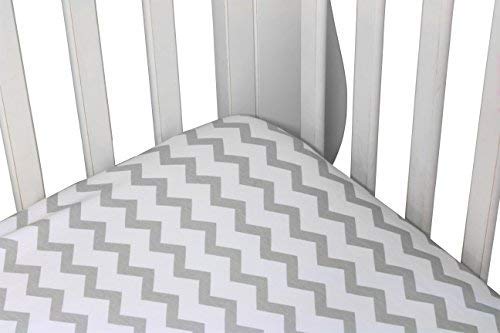 Ely's & Co waterproof crib sheet on mattress demonstrating leak protection.