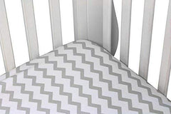 Ely's & Co waterproof crib sheet on mattress demonstrating leak protection.
