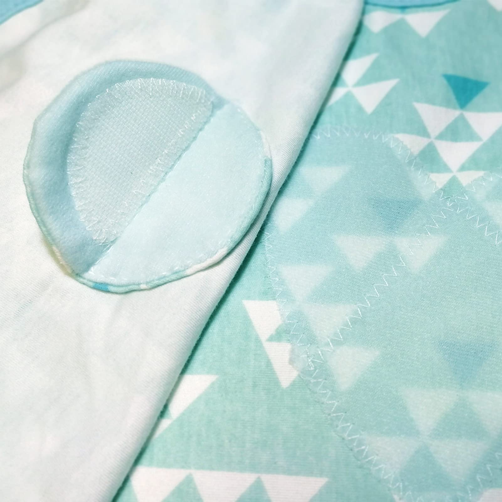 Enrich YLife swaddle sack green on-baby sleeping demonstrates calm, cozy nighttime rest.