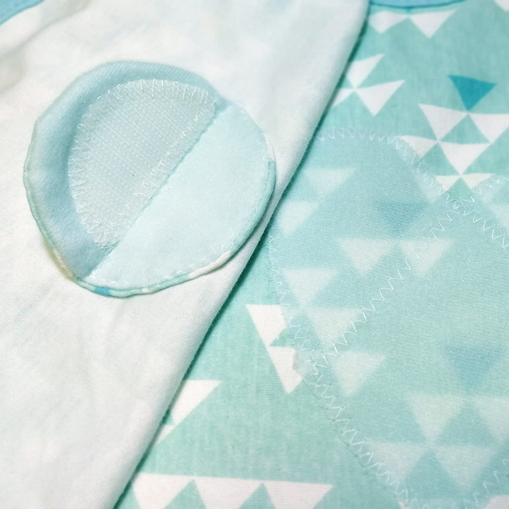 Enrich YLife swaddle sack green on-baby sleeping demonstrates calm, cozy nighttime rest.