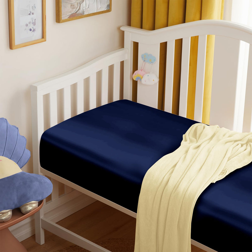 Entisn satin crib sheets 8inch-pocket image demonstrates snug fit on standard crib mattress.