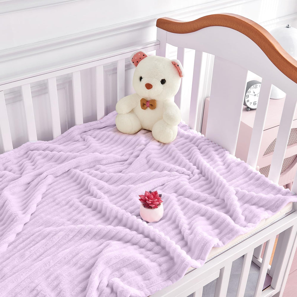 Eonkasp blanket draped over crib highlighting reversible stripes