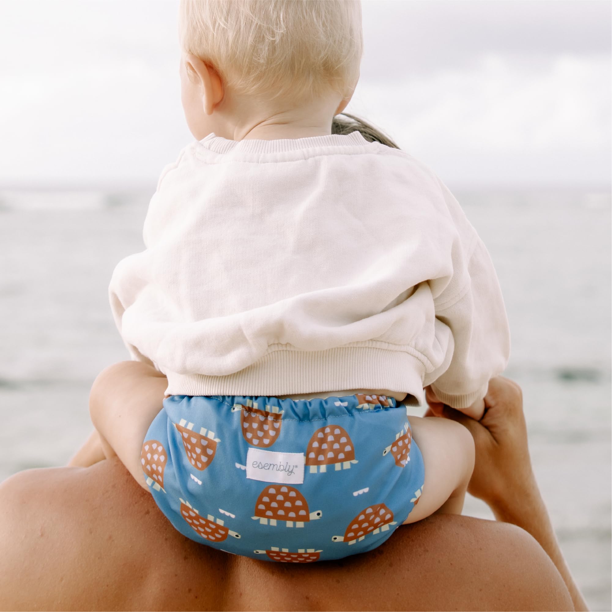 Esembly outer used as a reusable swim diaper for pool days with Turtle design.