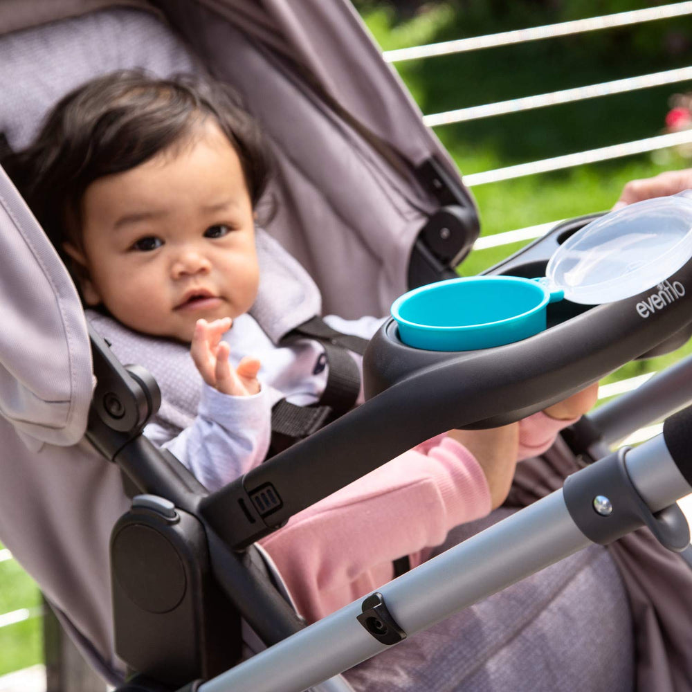 Evenflo stroller snack tray attaches and detaches for simple setup.