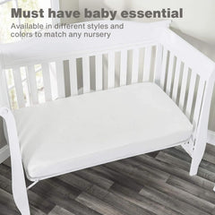 Everyday Kids navy sheet folded to illustrate snug crib fit.
