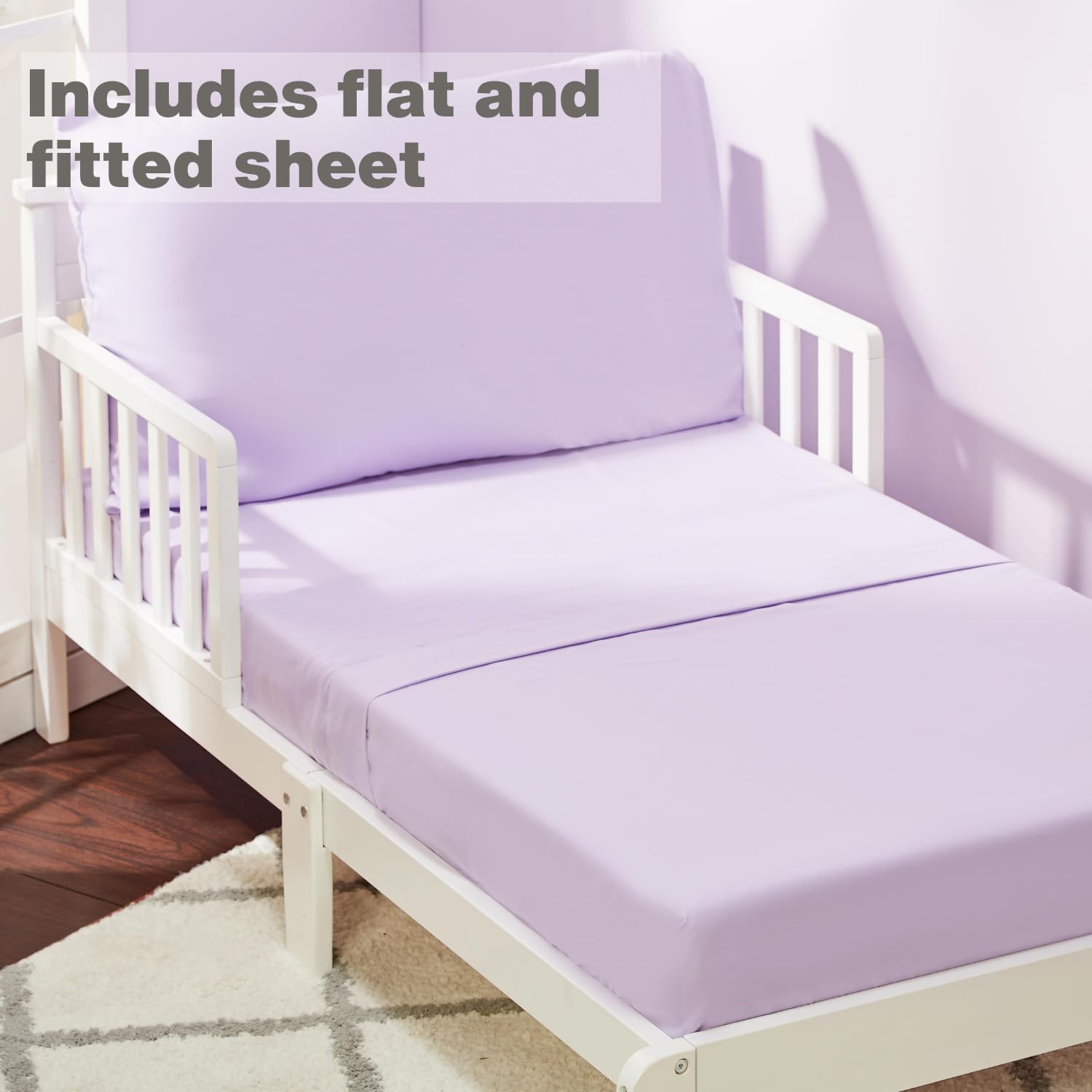 Everyday Kids solid purple fitted sheet on toddler mattress shows secure fit with 8-inch pocket.