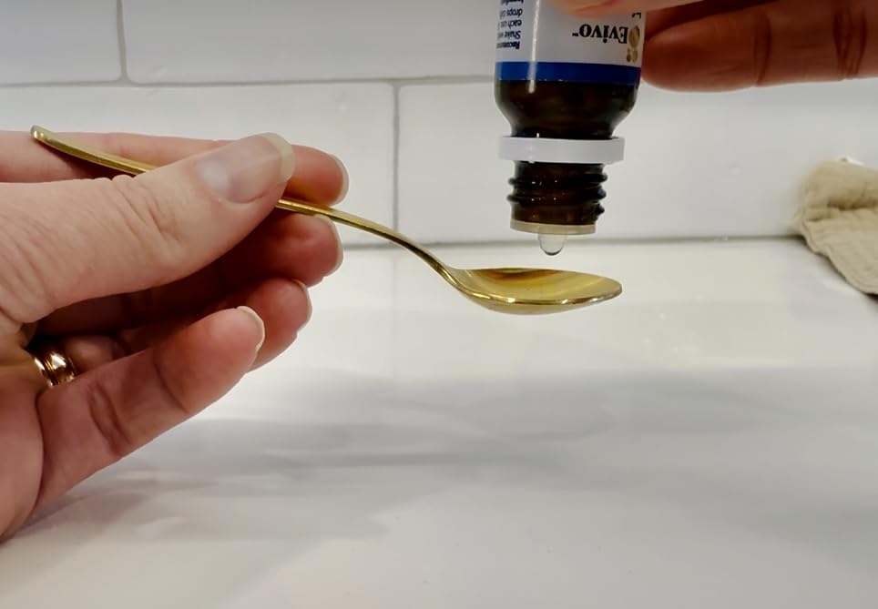 Smiling baby with Evivo drops, suggesting gentle digestive support