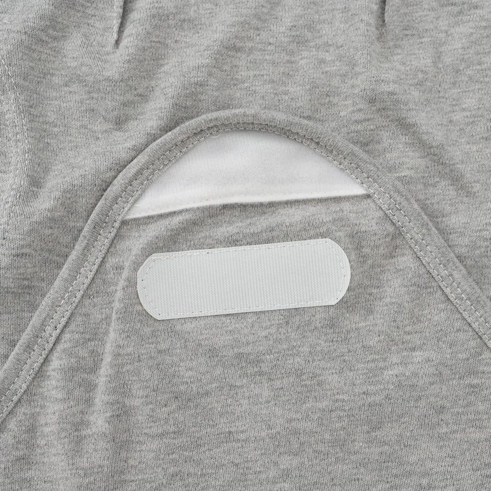 Exemaba hook-and-loop tabs secure inner cloth for easy, snug swaddling.