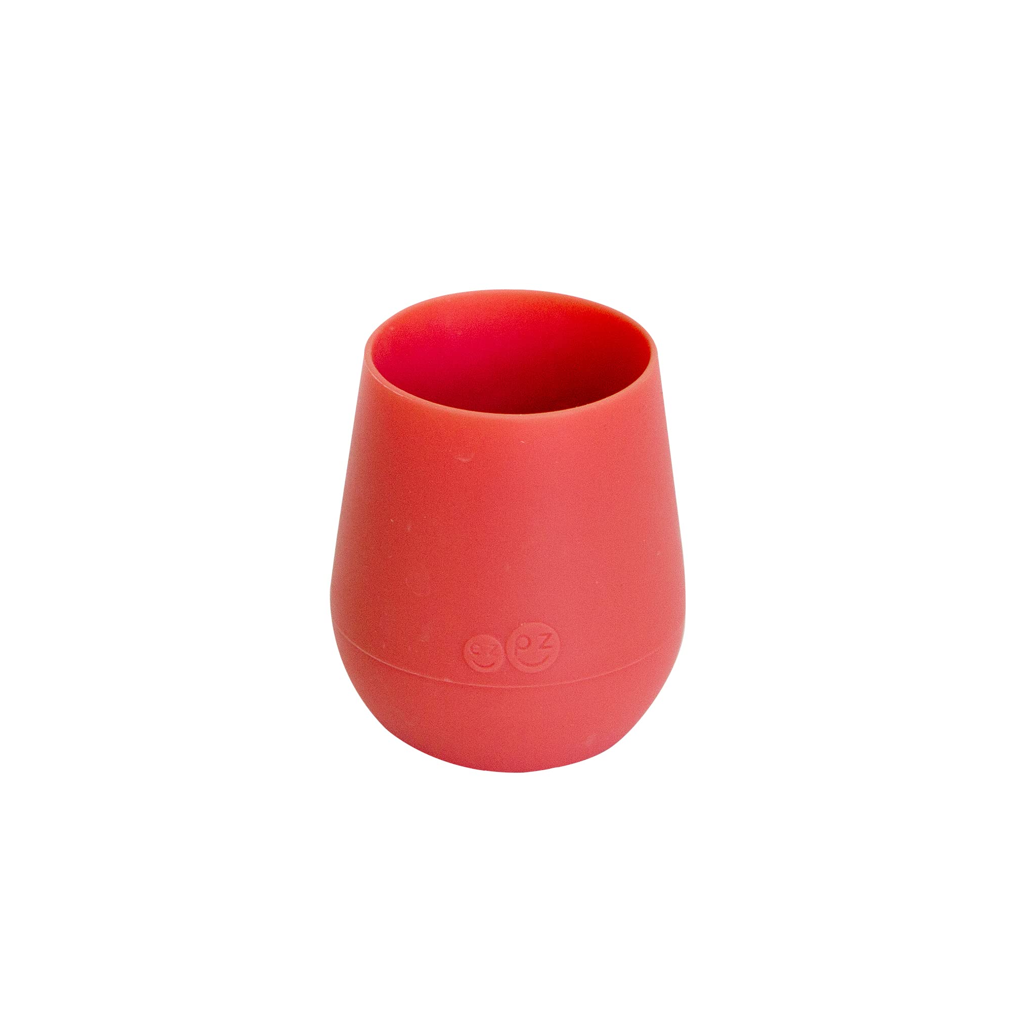 ezpz Tiny Cup Coral weighted base provides topple resistance on a table.