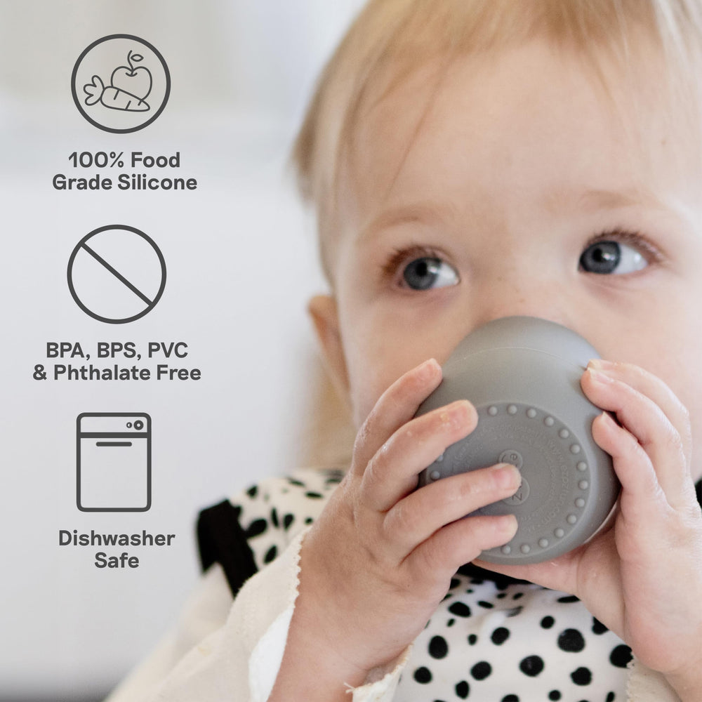 ezpz Tiny Cup Sage travel scene demonstrates mess-free feeding anywhere.