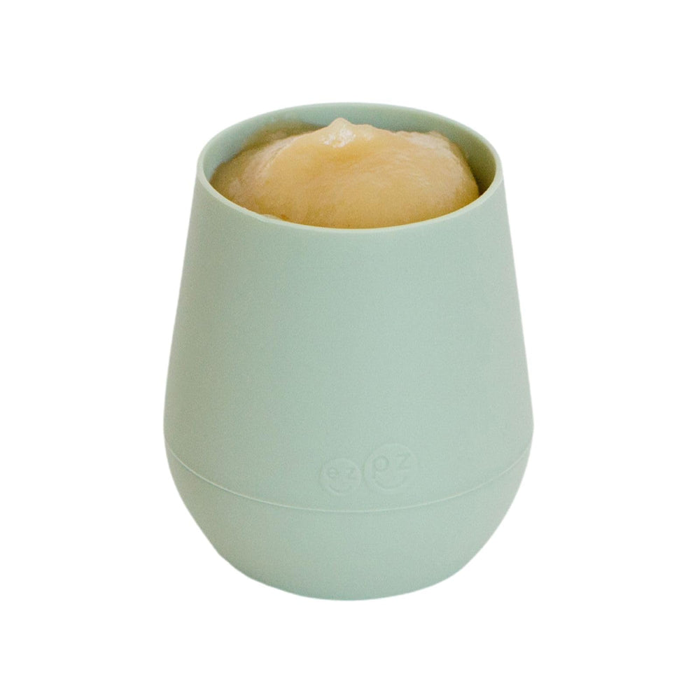 ezpz Tiny Cup Sage weighted-base image shows topple resistance during use.