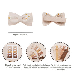 Fancy Clouds daisy embroidery closeup on clip highlights soft fabric and craftsmanship.