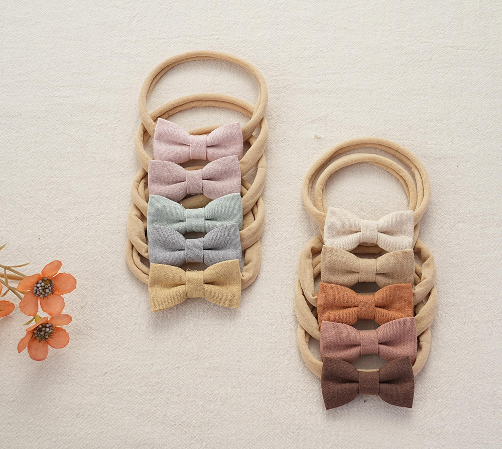 Fancy Clouds bows on a baby's head demonstrating secure fit during play