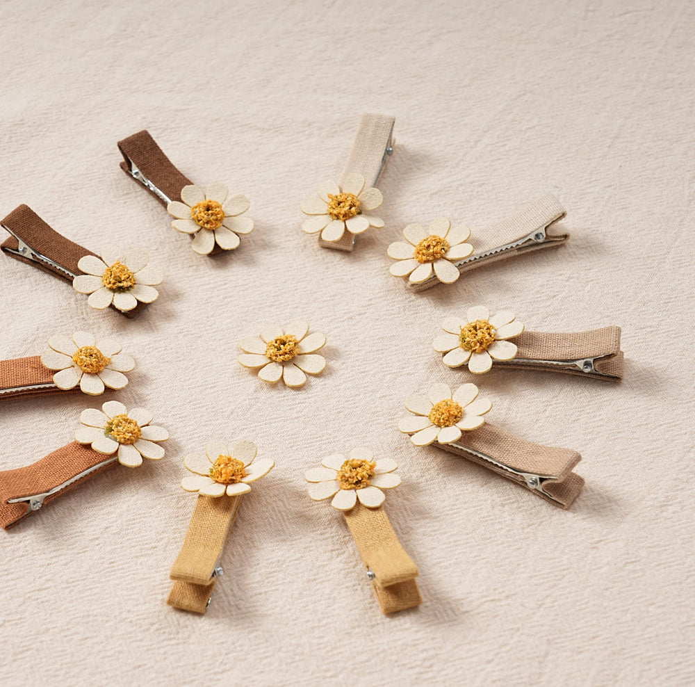 Fancy Clouds daisy clip close-up on hair demonstrating lightweight comfort