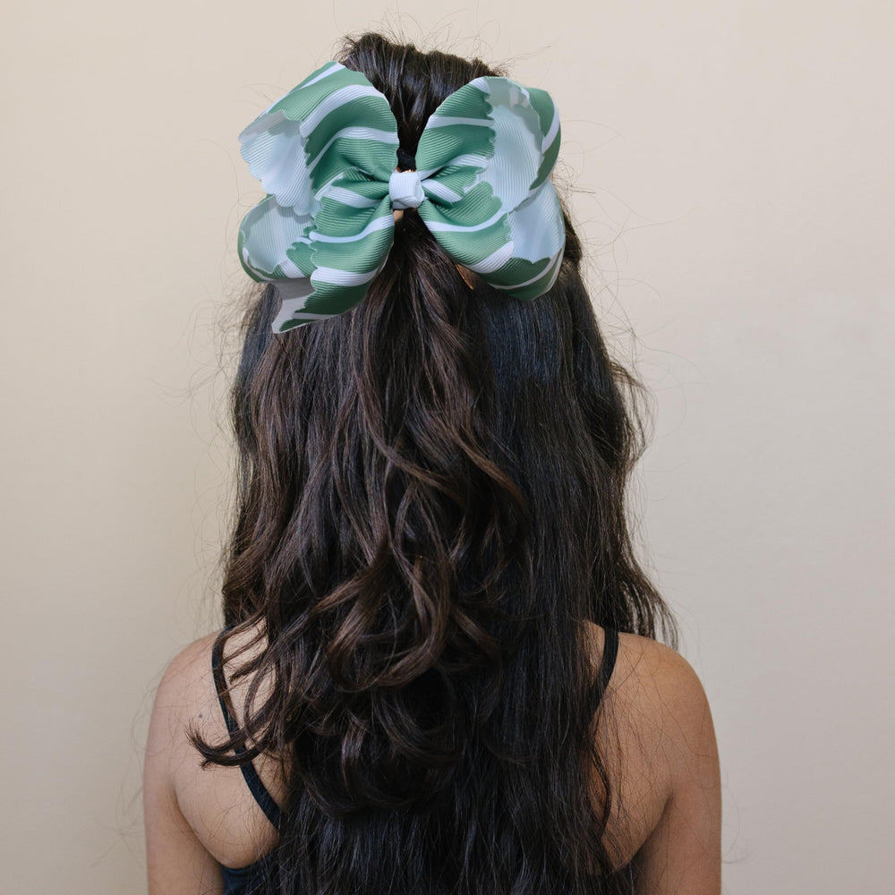 Fifi & Ry baby peach bow highlighting delicate look and gentle hold for fine hair