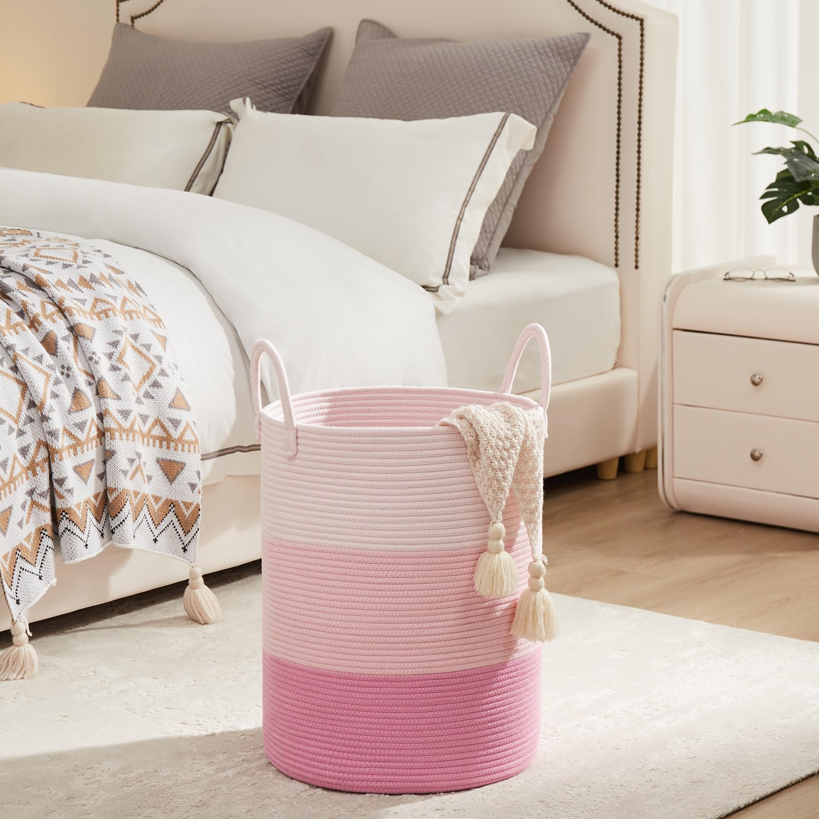 Fiona's magic pink nursery organization hamper shows versatile storage for baby blankets and toys.