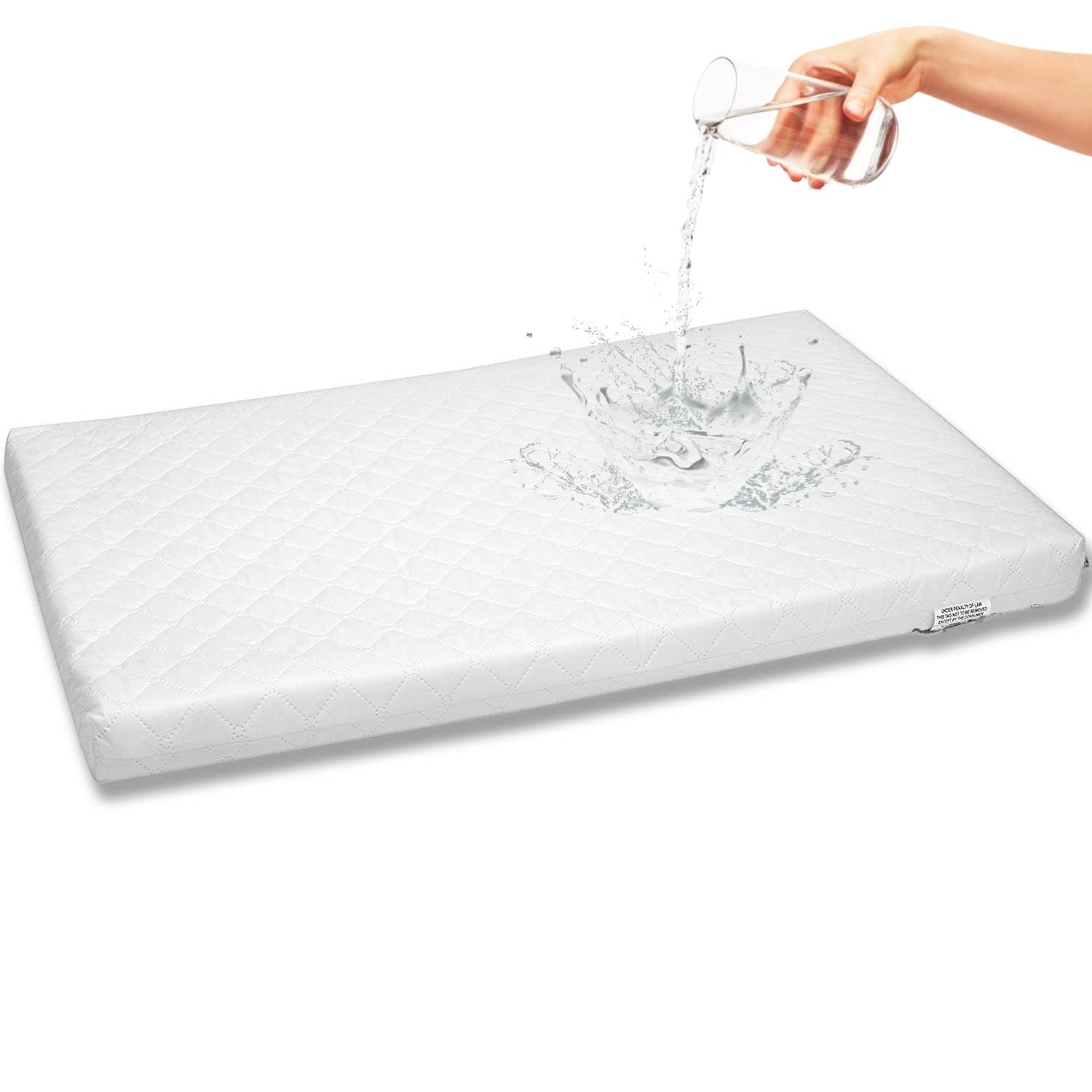 First Essentials bassinet mattress pad close-up shows foam support for newborn comfort.