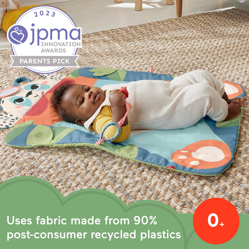 Fisher-Price Baby Planet Friends rolled mat secured for travel use.