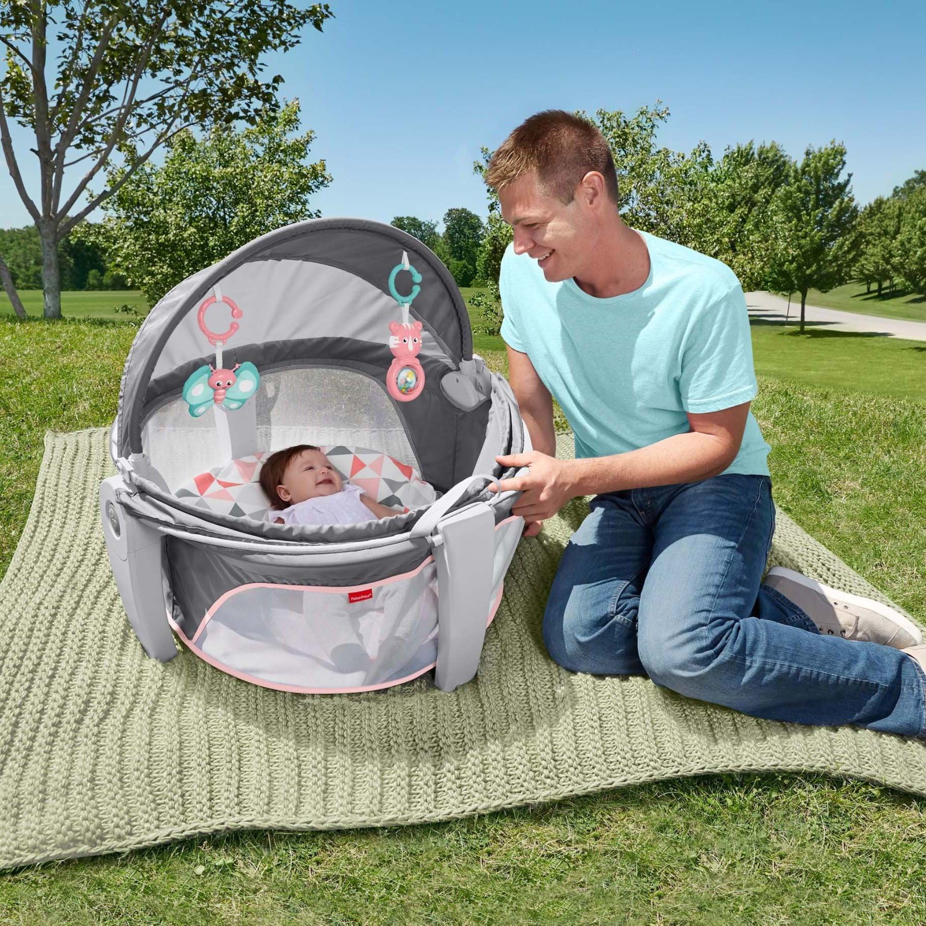 Fisher-Price portable bassinet developmental toys engage newborns with gentle motion.