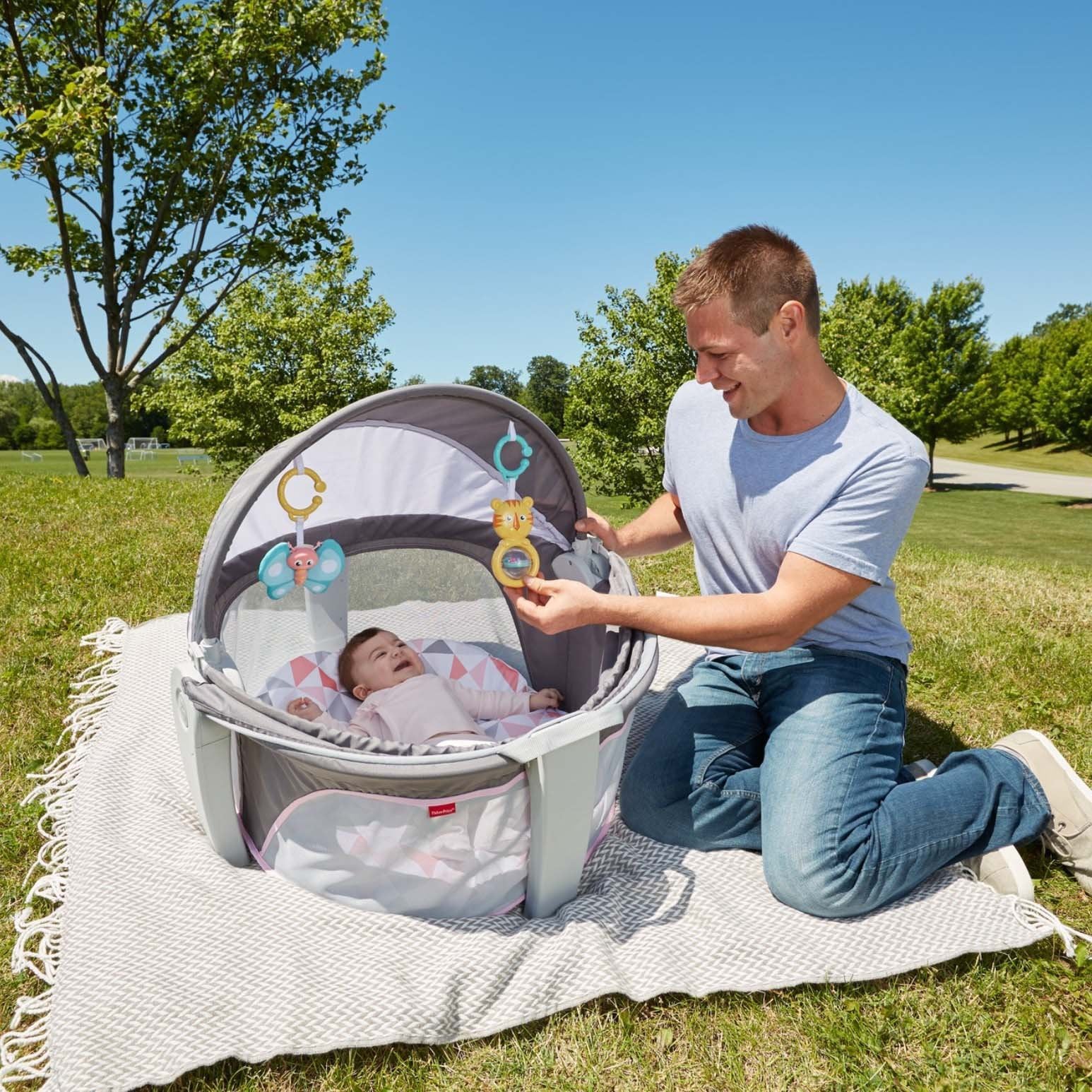 Fisher-Price portable bassinet handles provide effortless carry and setup.