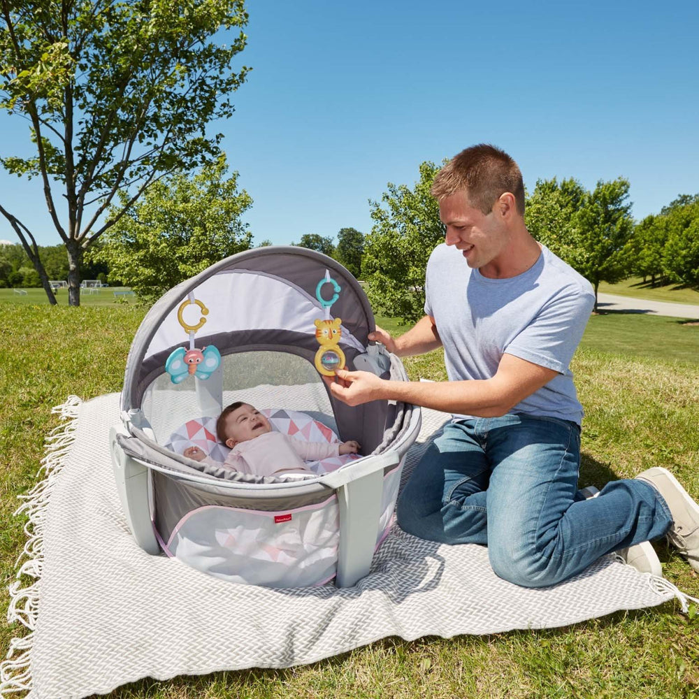 Fisher-Price portable bassinet handles provide effortless carry and setup.