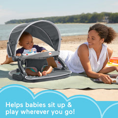 Fisher-Price Travel Baby Chair sun canopy provides shade for outdoor meals.