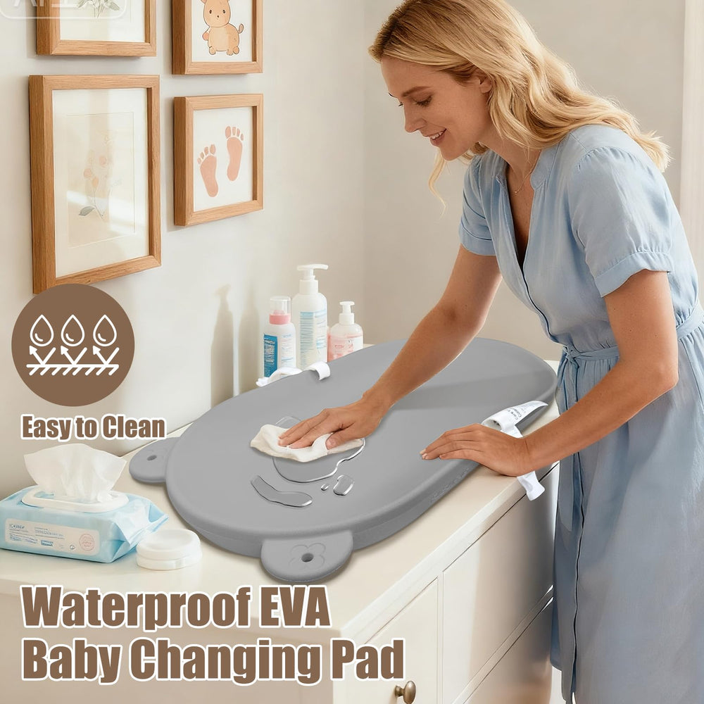 FLEUFAB changing pad open in use with secure strap for safe diaper changes.