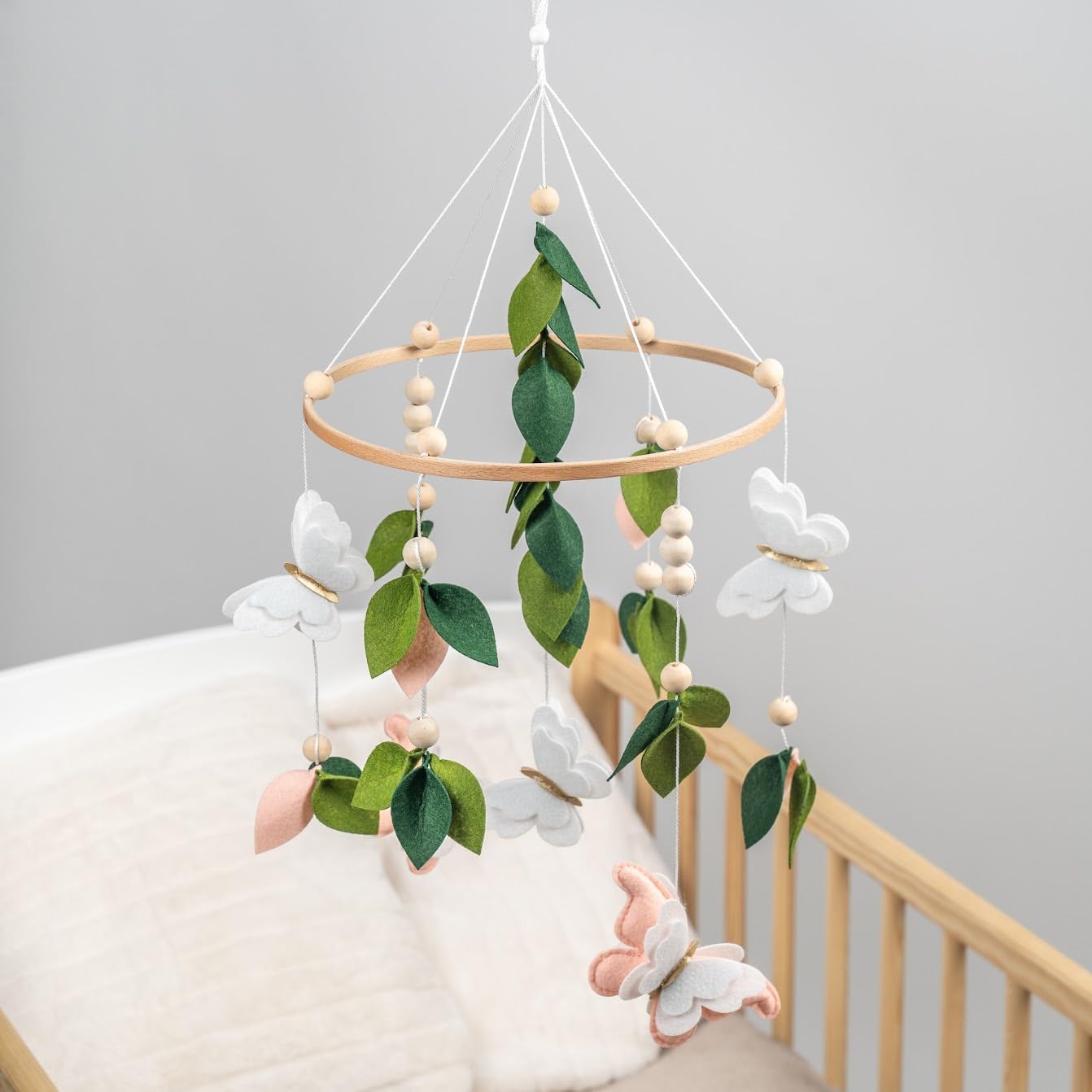 Flora & Ivy butterfly mobile boho nursery design complements eclectic spaces.