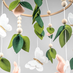 Flora & Ivy butterfly mobile pink-white-gold close-up shows handcrafted felt details and soft textures.