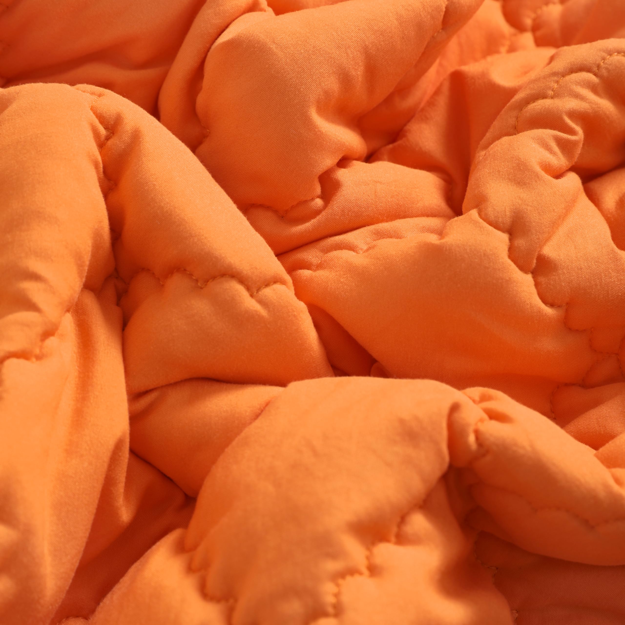 FLXXIE orange comforter on crib for cozy room decor