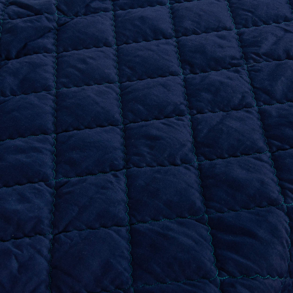 FLXXIE comforter stroller-use scene shows lightweight fabric for easy on-the-go cuddles.