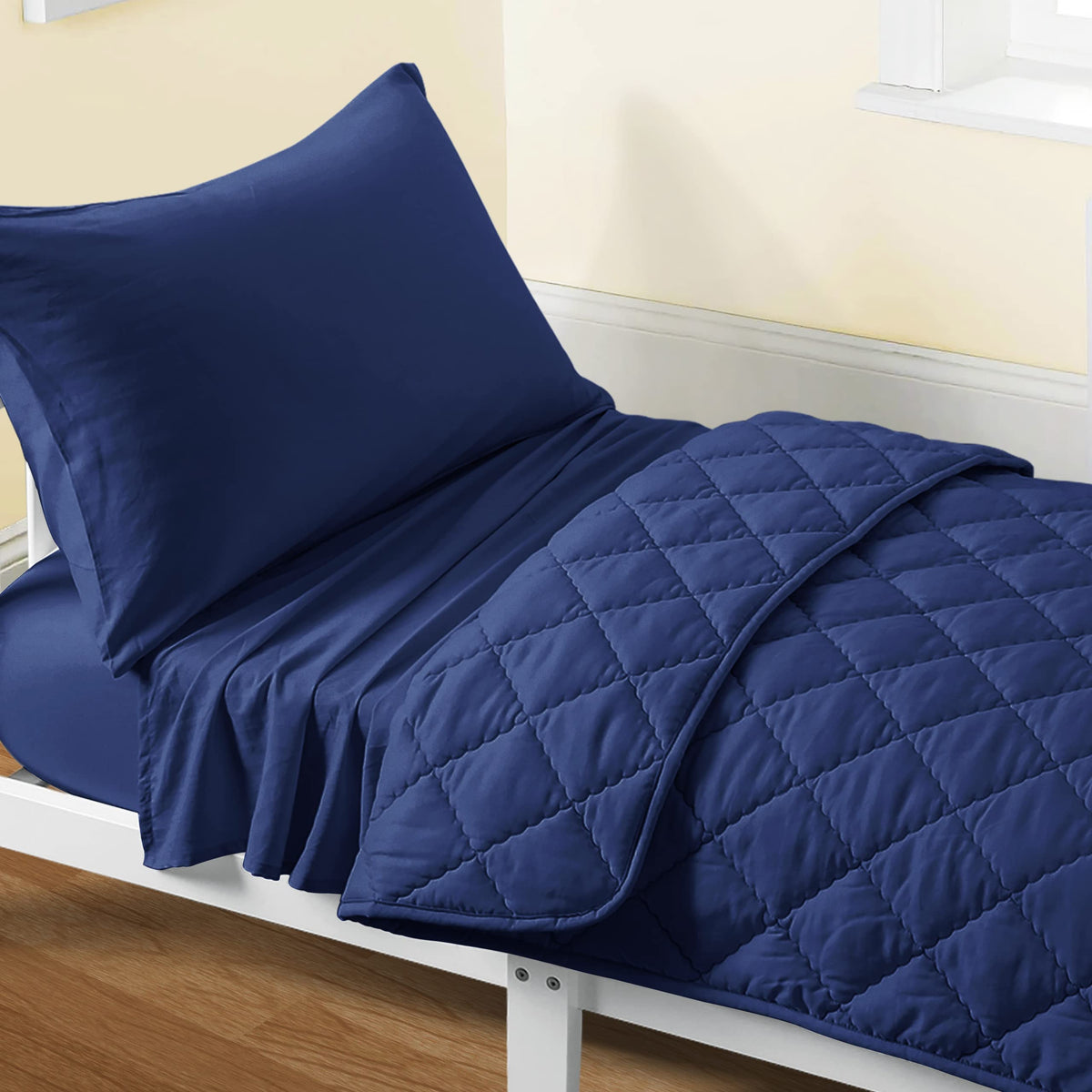 FLXXIE toddler bedding navy blue quilt closeup highlighting soft microfiber comfort for quiet nights.