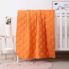 FLXXIE toddler comforter orange folded—travel-friendly warmth