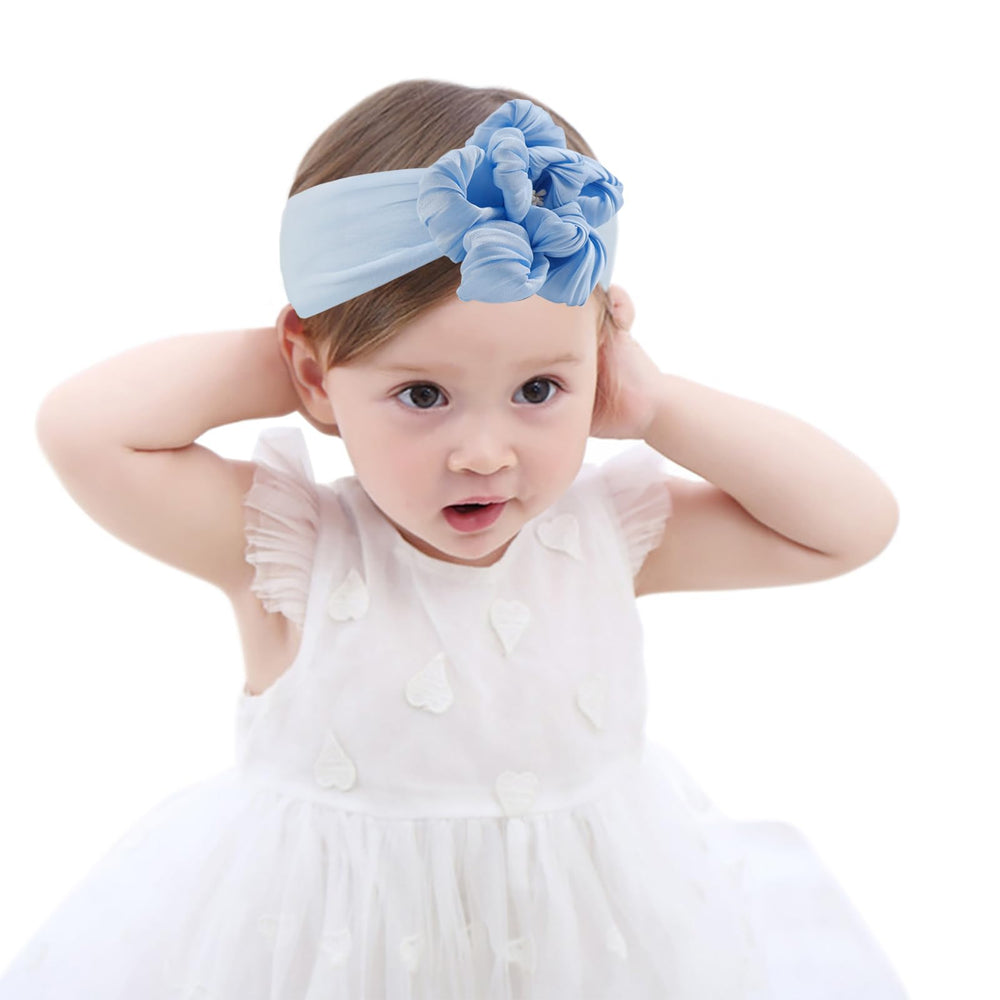 Fmeida baby headband with blue big flower on a newborn for adorable photos.