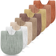 Frienda 8-pack muslin bibs in warm colors laid out for daily use.
