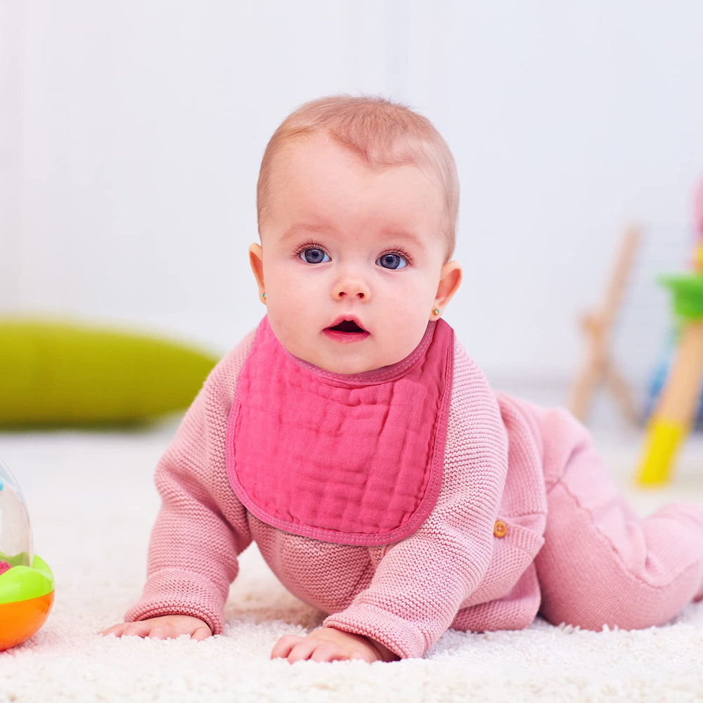 Frienda pink-series muslin bibs six-pack on table showing gentle skin-friendly material.